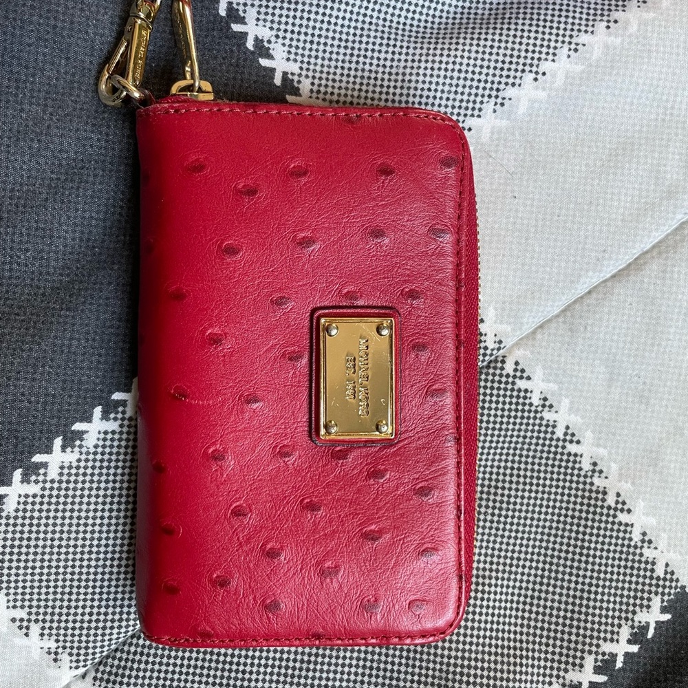 Barely used red Michael Kors wristlet. Slightly flexible on price.